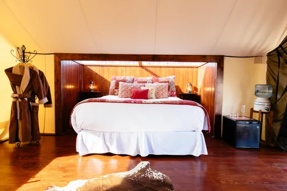 A king bed with lavish linens and custom sky light for star gazing