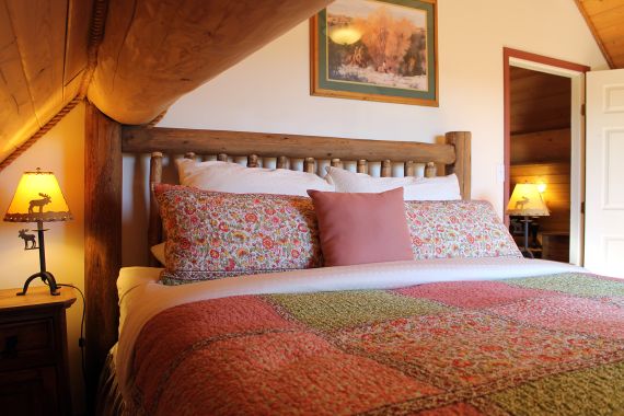 King bed in the Cariboo Barn Loft Suite at Siwash Lake