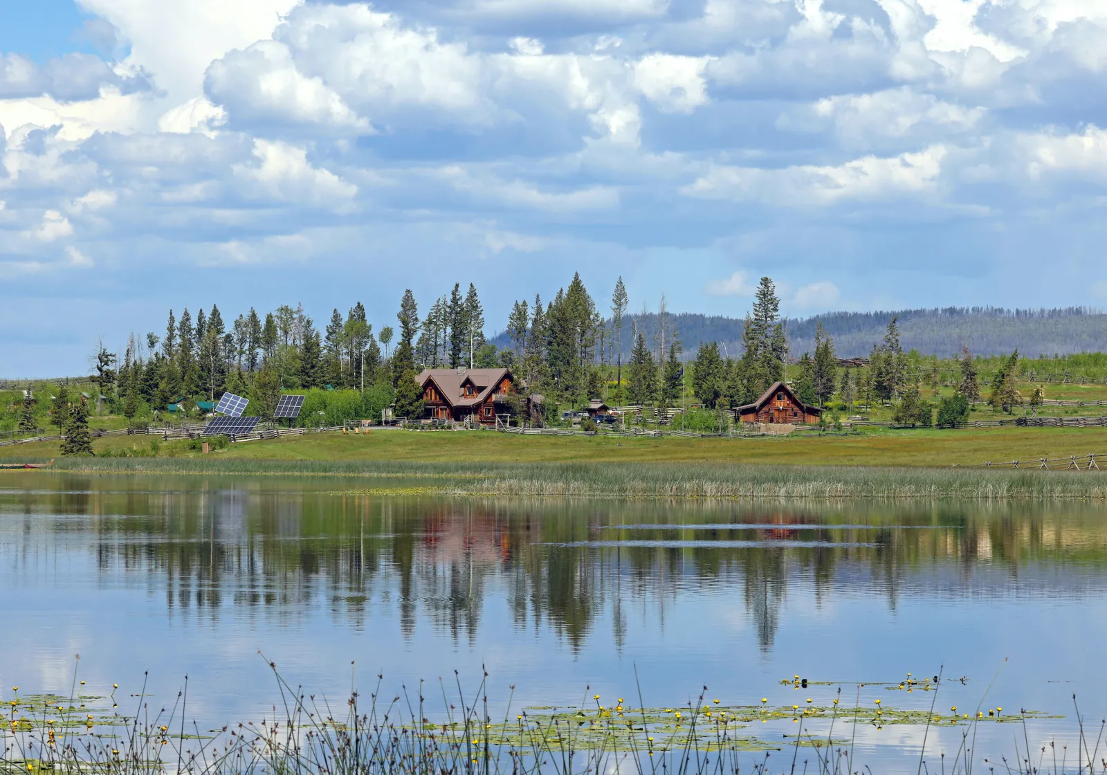The authentic ranch at Siwash Lake with log lodge and barn overlooking a shimmering wilderness lake