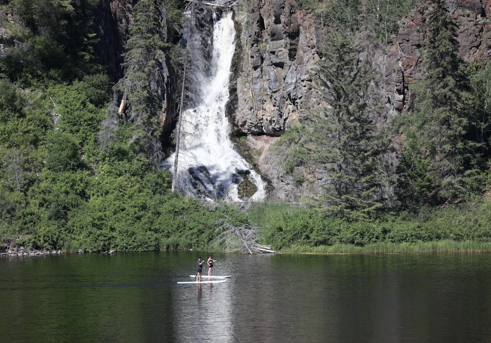 5-Star wilderness adventures at Siwash Lake wilderness resort and luxury dude ranch include paddle boarding next to waterfalls