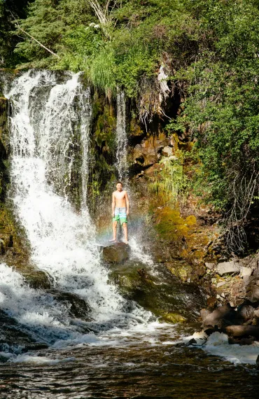 Shower under the falls at Siwash Lake Wilderness Resort