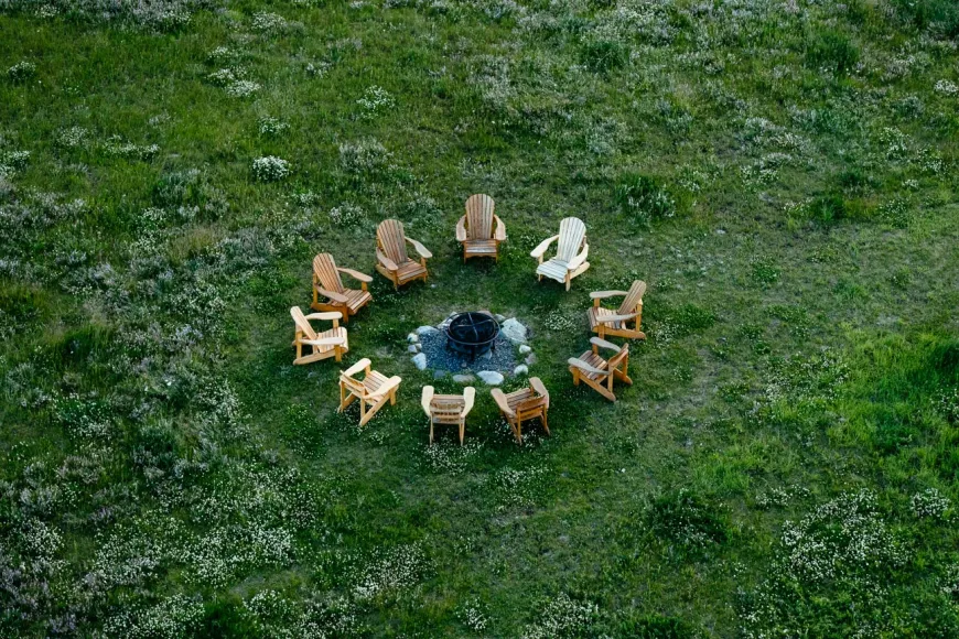 The campfire pit in a wild meadow awaits for families to gather around the campfire