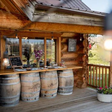 The barrel bar is set up on the front porch of the authentic Ranch House